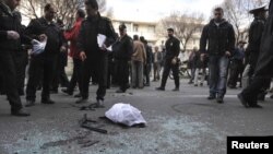 Iranian investigators gather evidence at the site of the blast near a university in northern Tehran.