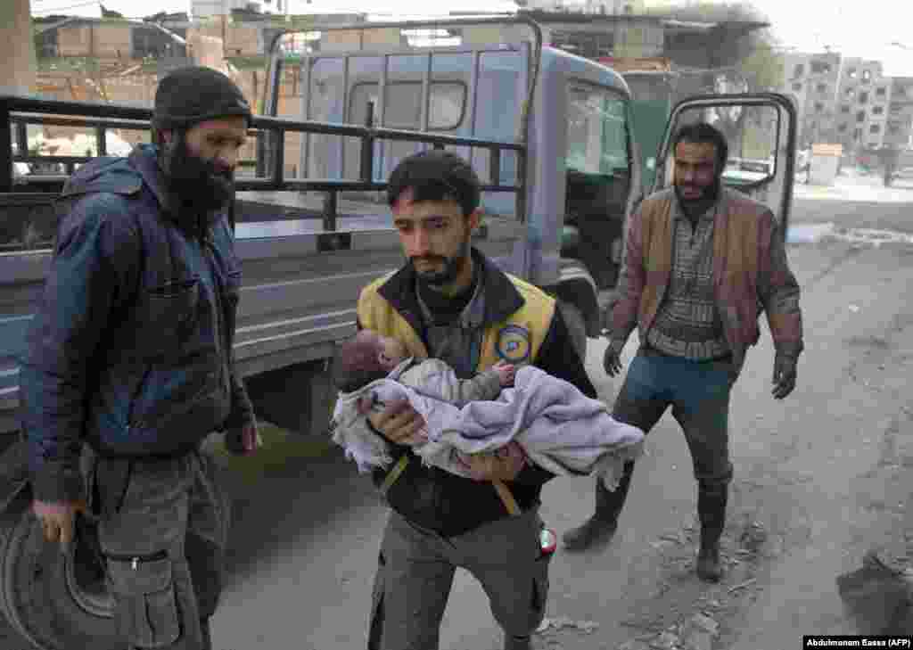 Syrians flee their homes in the town of Beit Sawa in the besieged eastern Ghouta region on March 4 following reported air strikes. (AFP/Abdulmonam Eassa)