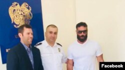 Armenia - Mnatsakan Bichakhchian C), the head of an Armenian police department on visas and passports, poses for a photo with U.S. celebrity Dan Bilzerian (R) and his brother Adam in Yerevan, 27 August 2018.