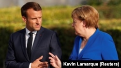 German Chancellor Angela Merkel (right) and French President Emmanuel Macron are the most confidence-inspiring world leaders according to a new global survey. 