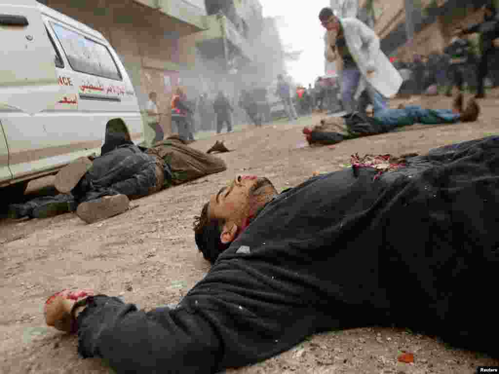 Unidentified bodies lie on a street in the Jabalya refugee camp in northern Gaza Strip early March 6, 2003. Israeli forces killed at least 11 Palestinians and injured more than 140, including some torn apart by a tank shell, in a major raid in the Gaza Strip on Thursday after a suicide bomber killed 15 people in Israel yesterday. REUTERS/Ahmed Jadallah 