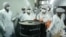 Iranian technicians remove a container of radioactive uranium for use at a uranium conversion facility in 2005. (file photo)
