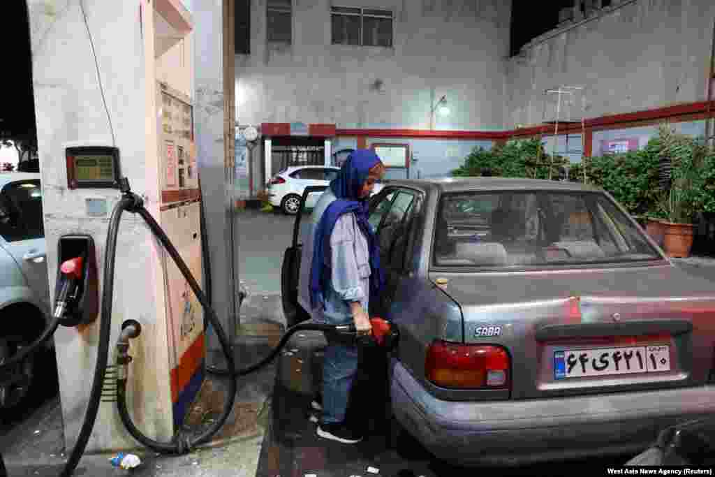 An Iranian woman fills up her car in Tehran amid fears an Israeli attack could target Iran&#39;s oil industry.&nbsp;