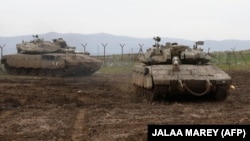 Israeli Army tanks gather in the Golan Heights on January 20 after Israeli air defenses intercepted a rocket fired from Syria.