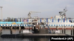 IRAN -- Iranian President Hassan Rohani and other dignitaries attend the inauguration of Fateh, "Conqueror" in Persian, Iranian made semi-heavy submarine in the southern port of Bandar Abbas, February 17, 2019