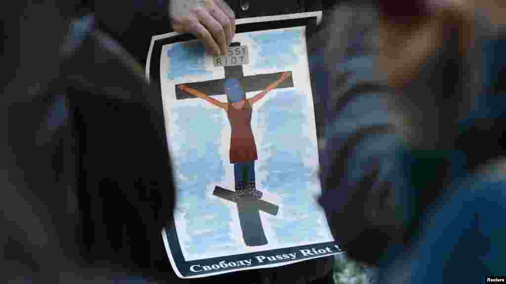 An activist holds a poster during in support of the three jailed members of Pussy Riot.