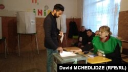 A young Georgian man casts his vote in Marneuli on October 28. 