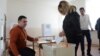 Armenia -- A woman casts a ballot in a constitutional referendum, Yerevan, 6Dec2015.