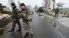 Ukrainian soldiers stand guard at a checkpoint on the outskirts of the town of Kostyantynivka in January.