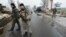 Ukrainian soldiers stand guard at a checkpoint on the outskirts of the town of Kostyantynivka in January.