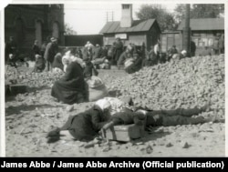 Hungry and exhausted peasants wait by the railroad tracks in Kharkiv in 1932.