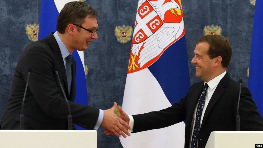 Serbian Prime Minister Aleksandar Vucic (left) and Russian Prime Minister Dmitry Medvedev shake hands at a press conference in Moscow on July 7.