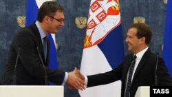 Serbian Prime Minister Aleksandar Vucic (left) and Russian Prime Minister Dmitry Medvedev shake hands at a press conference in Moscow on July 7.