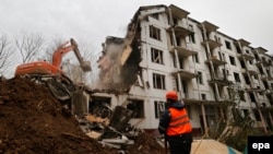 Workers demolish a five-story "Khrushchyovka" in Moscow in October 2016.