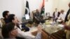 Asif Ali Zardari (center) talks with party workers before his arrest by the NAB in Islamabad in June 2019.