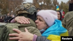 A Kherson resident embraces a Ukrainian soldier after the city's liberation on November 12.