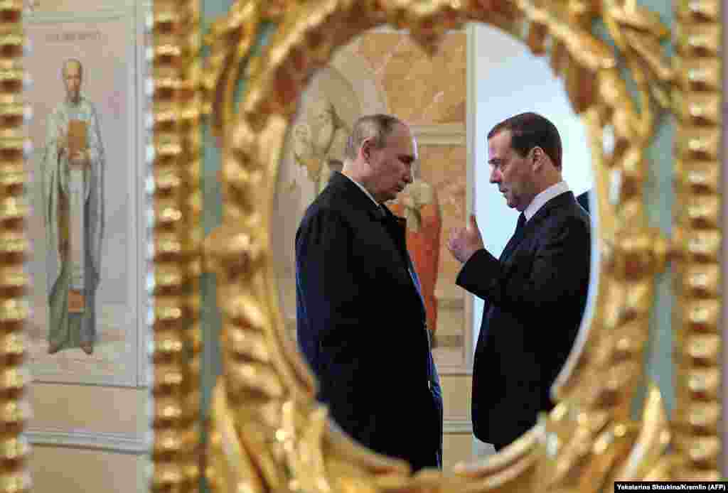 Russian President Vladimir Putin (left) and Prime Minister Dmitry Medvedev visit the New Jerusalem Orthodox Monastery near the town of Istra, some 70 kilometers outside of Moscow. (AFP/Yekaterina Shtukina)