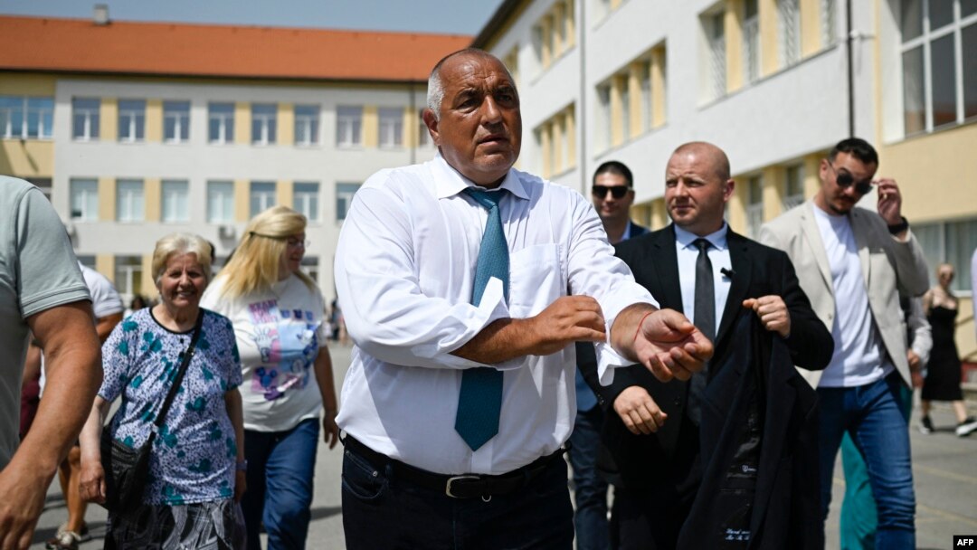 Former Bulgarian Prime Minister Boyko Borisov leaves a polling station after casting his ballot during the snap parliamentary and European Parliament elections at a polling station in Sofia on June 9.
