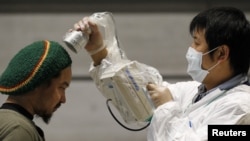 A man is tested for possible radiation exposure at an evacuation center in Kuriayama, Fukushima Prefecture, on March 29.