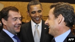 Portugal -- Presidents Barack Obama (C), Dmitry Medvedev (L) and Nicolas Sarkozy joke prior to the NRC (NATO-Russian Council) on 20Nov10 in Lisbon. 