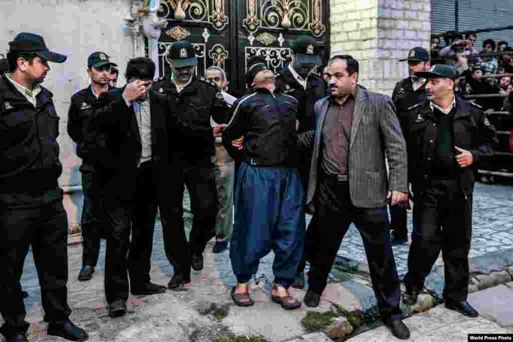 Arash Khamooshia, an Iranian photographer, won Third Prize in the Spot News Category for a photo showing Iranian authorities escorting a condemned murderer, Balal, who was spared the gallows when, moments before the sun rose, the victim&#39;s mother pardoned him by slapping his face instead of pulling the chair from underneath his feet.&nbsp; &nbsp;