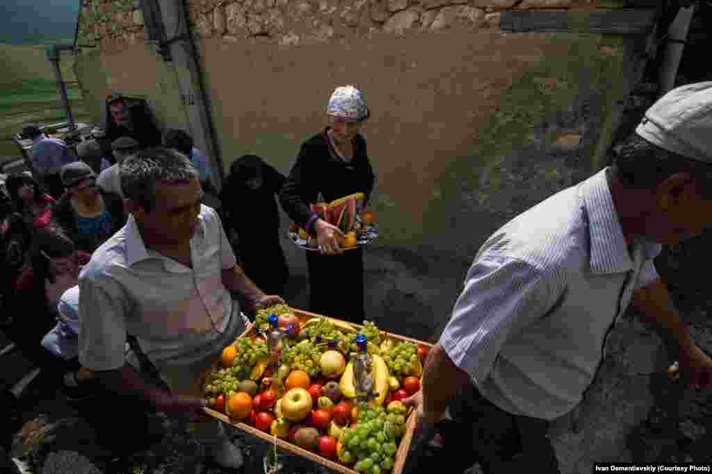 Villagers transport food to an open-air hilltop wedding feast.&nbsp;