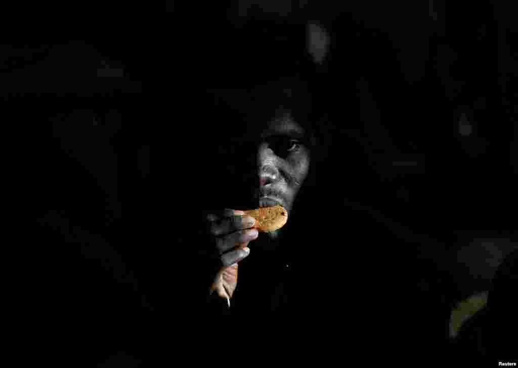 A migrant eats a biscuit on the Migrant Offshore Aid Station (MOAS) ship Topaz Responder after being rescued around 20 nautical miles off the coast of Libya. (Reuters/Darrin Zammit Lupi )