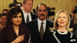 U.S. Secretary of State Hillary Clinton (far right) with Pakistan's Foreign Minister Hina Rabbani Khar (far left) in Islamabad. 