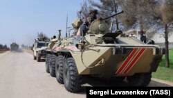 A Russian Army armored personnel carrier is seen on a joint patrol on the M4 motorway with Turkish troops on the western outskirts of the city of Saraqib in the Idlib region in March.