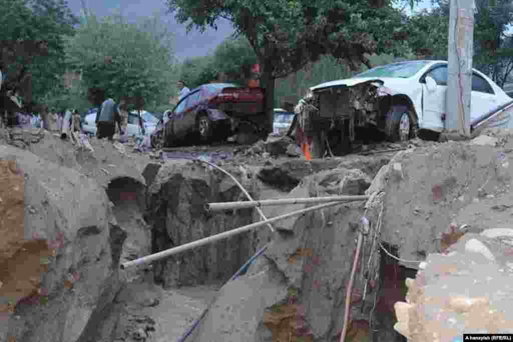 Flooding tore up roads and upended vehicles in Charikar.