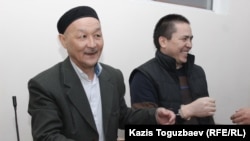 Kenzhebek Abishev (left) and Almat Zhumagulov appear in the court during their trial in Almaty in September 2018.