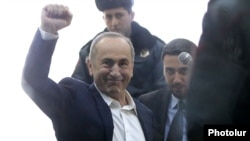 Former President Robert Kocharian greets supporters during his trial in Yerevan on February 25.