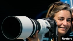 AP photographer Anja Niedringhaus laughs as she attends a swimming event at the 2004 Olympic Games in Athens.