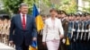 Ukrainian President Petro Poroshenko (left) and Estonian President Kersti Kaljulaid review the honor guard during a welcome ceremony ahead of their meeting in Kyiv on May 22.