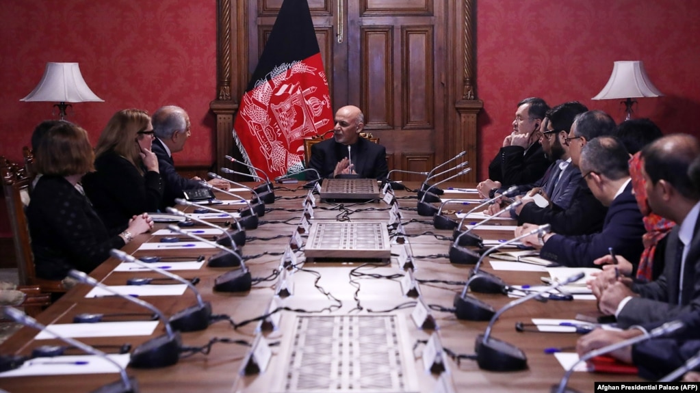 Afghan President Ashraf Ghani (center) talks with U.S. special representative for Afghan peace and reconciliation, Zalmay Khalilzad (upper left), during a cabinet meeting at the Presidential Palace in Kabul on January 27.