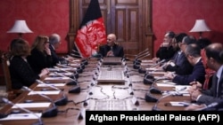 Afghan President Ashraf Ghani (center) talks with U.S. special representative for Afghan peace and reconciliation, Zalmay Khalilzad (upper left), during a cabinet meeting at the Presidential Palace in Kabul on January 27.