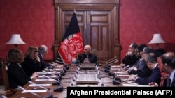 Afghan President Ashraf Ghani (center) talks with U.S. special representative for Afghan peace and reconciliation, Zalmay Khalilzad (upper left), during a cabinet meeting at the Presidential Palace in Kabul on January 27.