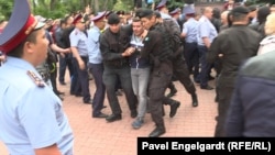 Kazakh police detain RFE/RL reporter Pyotr Trotsenko near the site of a protest against the presidential election in Almaty on June 9.
