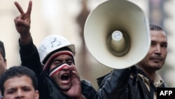 Antigovernment protesters shout slogans outside the Egyptian parliament.