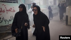 Protesters chant slogans after Bahraini police used a stun grenade during an antigovernment rally in Manama on April 19.