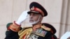 (FILES) In this file photo taken on November 29, 2010 Oman’s Sultan Qaboos bin Said salutes at the start of a military parade at a stadium in Muscat on the occasion of the Sultanate's 40th National Day. 