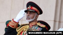 (FILES) In this file photo taken on November 29, 2010 Oman’s Sultan Qaboos bin Said salutes at the start of a military parade at a stadium in Muscat on the occasion of the Sultanate's 40th National Day. 
