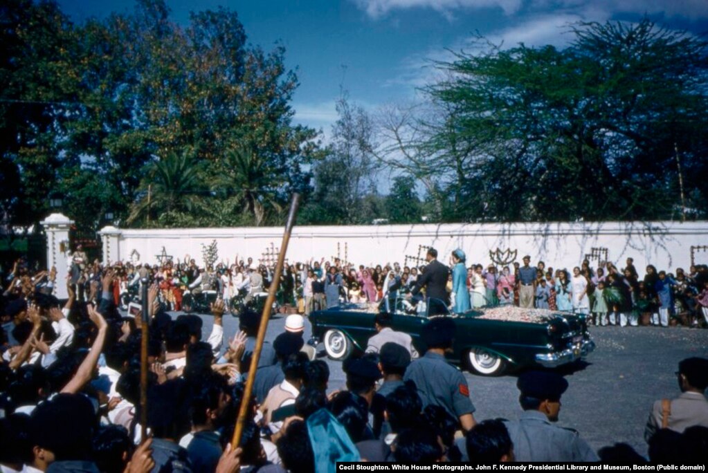 The view from the crowd as the motorcade passes. In addition to flower petals, Clint Hill, a Secret Service agent in charge of security, recalls that occasionally a "whole damn bouquet" would come flying at the car. "I'd have to rise out of my seat to fend it off so it didn't knock her in the head."
