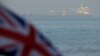 The British Union Jack flag flies in front of Iranian oil tanker Grace 1 as it sits anchored after it was seized in July by British Royal Marines off the coast of the British Mediterranean territory on suspicion of violating sanctions against Syria, in th