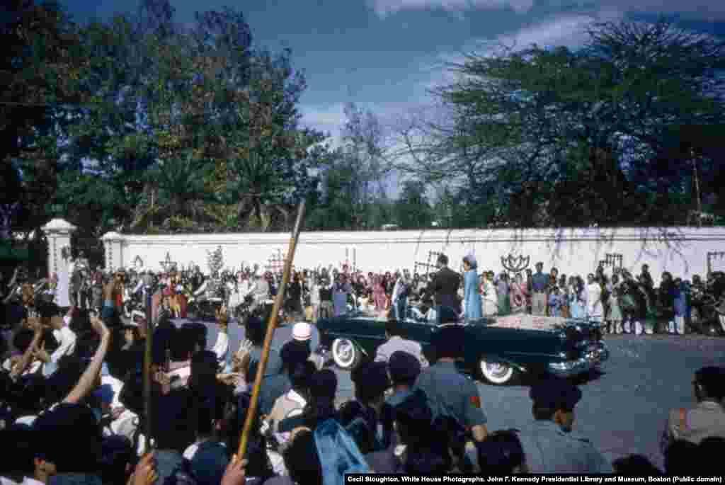 The view from the crowd as the motorcade passes. In addition to flower petals, Clint Hill, a Secret Service agent in charge of security, recalls that occasionally a &quot;whole damn bouquet&quot; would come flying at the car. &quot;I&#39;d have to rise out of my seat to fend it off so it didn&#39;t knock her in the head.&quot;