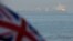 The British Union Jack flag flies in front of Iranian oil tanker Grace 1 as it sits anchored after it was seized in July by British Royal Marines off the coast of the British Mediterranean territory on suspicion of violating sanctions against Syria, in th