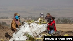 Rescuers work at the scene of an Ethiopian Airlines flight crash in Ethiopia, Monday, March 11, 2019.