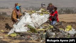 Rescuers work at the scene of the Ethiopian Airlines crash on March 11.