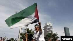 A demonstrator waves a Palestinian flag during a protest against Israel in front of the Israeli Consulate in Istanbul on May 31.