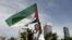 A demonstrator waves a Palestinian flag during a protest against Israel in front of the Israeli Consulate in Istanbul on May 31.